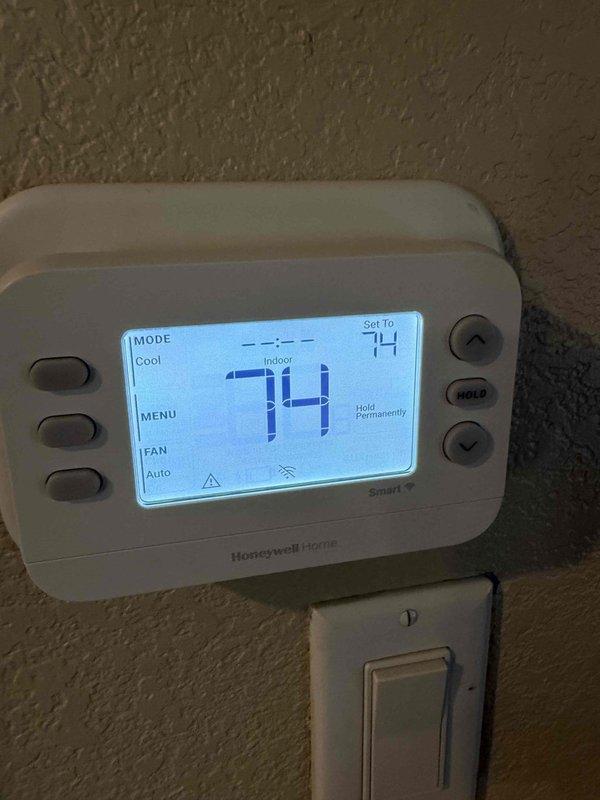Responded to service call for thermostat intermittently shutting down completely then restarting on 15-month-old Friedrich heat pump system located in attic of 2,654 square foot residence. Performed comprehensive system diagnostic including condenser inspection, evaporator coil evaluation, and furnace/air handler assessment. Verified Honeywell programmable thermostat operation, confirmed system currently maintaining 74°F setpoint in cooling mode with auto fan operation, and completed full energy efficiency checklist covering all major components including ductwork and indoor air quality parameters.