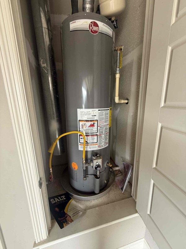 Responded to service call for pressure reducing valve repair and water heater evaluation. Inspected 9-year-old Rheem tank water heater installed in interior utility closet, noting flexible gas line connection, copper supply lines, and TPR valve discharge piping. Assessed PRV system at exterior main water line access point and provided repair recommendations. Documented equipment condition with photographs and provided replacement quote for aging water heater unit approaching end of typical service life.
