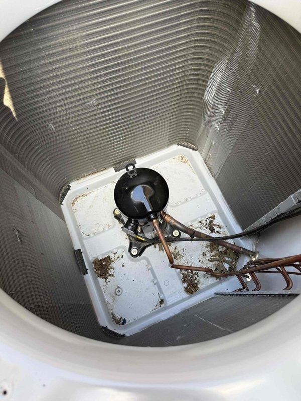 Responded to no cooling complaint on 1-year-old system located in attic. Performed diagnostic testing of outdoor unit electrical components using multimeter, measuring 78.1 volts at contactor. Inspected indoor air handler evaporator coil assembly and condensate drain pan, noting accumulated debris and staining around drain pump area. Identified and addressed cooling deficiency through electrical system verification and component inspection to restore proper system operation.