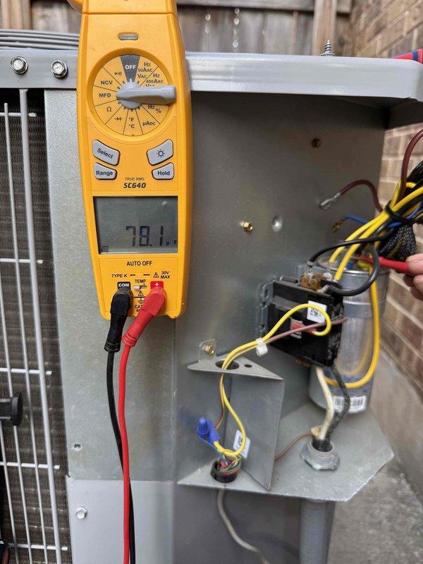 Responded to no cooling complaint on 1-year-old system located in attic. Performed diagnostic testing of outdoor unit electrical components using multimeter, measuring 78.1 volts at contactor. Inspected indoor air handler evaporator coil assembly and condensate drain pan, noting accumulated debris and staining around drain pump area. Identified and addressed cooling deficiency through electrical system verification and component inspection to restore proper system operation.