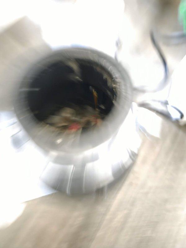 Responded to service call for inoperative garbage disposal unit that was receiving power but failing to rotate. Upon inspection, discovered the disposal flywheel was jammed with accumulated debris and foreign material lodged in the grinding chamber. Manually freed the impeller assembly, removed obstructing material, and restored full operational function. Tested unit under running water to verify proper grinding action and drainage, confirming complete resolution of the issue.