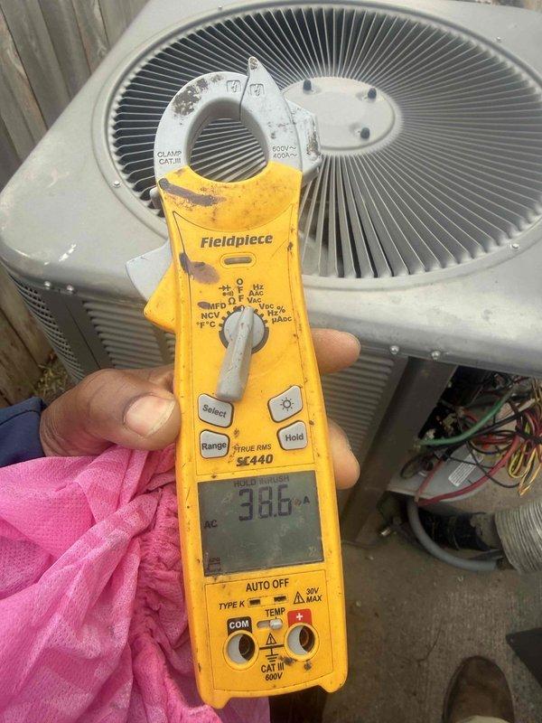 Returned to complete outstanding work on the outdoor condensing unit. Inspected the electrical control compartment, verifying contactor terminations and low- and line-voltage wiring integrity, and used a clamp meter in inrush-hold mode to measure amperage draw (38.6 A) during startup. Wiring was found intact with no signs of damage, corrosion, or frost, and the unit's electrical components were confirmed to be operating properly.