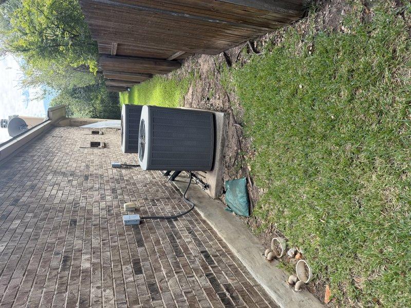 Conducted a sales evaluation of two central HVAC split systems installed in 2009, inspecting both outdoor condensing units, electrical disconnect and conduit connections, and refrigerant line sets. Noted weathered, deteriorating foam insulation on the suction line, with no visible frost, rust, or physical damage to the condensers. Based on system age, assessed replacement options for the aging equipment.