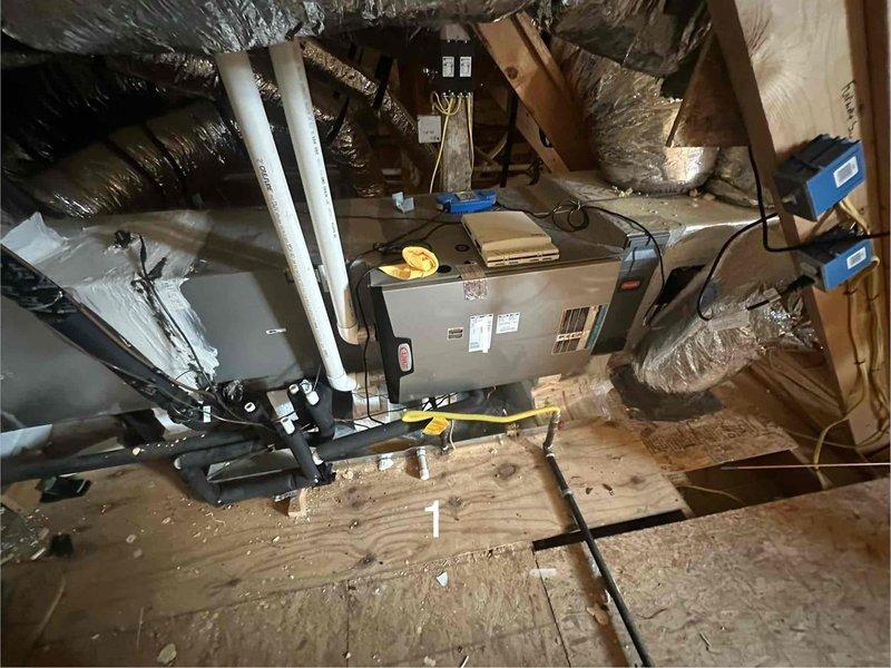 Performed a member maintenance inspection on two attic-mounted split systems, including inspection of the air handler, condensate drain lines, refrigerant line sets, and gas connection. Replaced the main filters as requested by the homeowner and verified system operation. Noted rust and corrosion on the galvanized duct collars at the underside of the supply plenum, which should be monitored or repaired to prevent air leakage and further deterioration.
