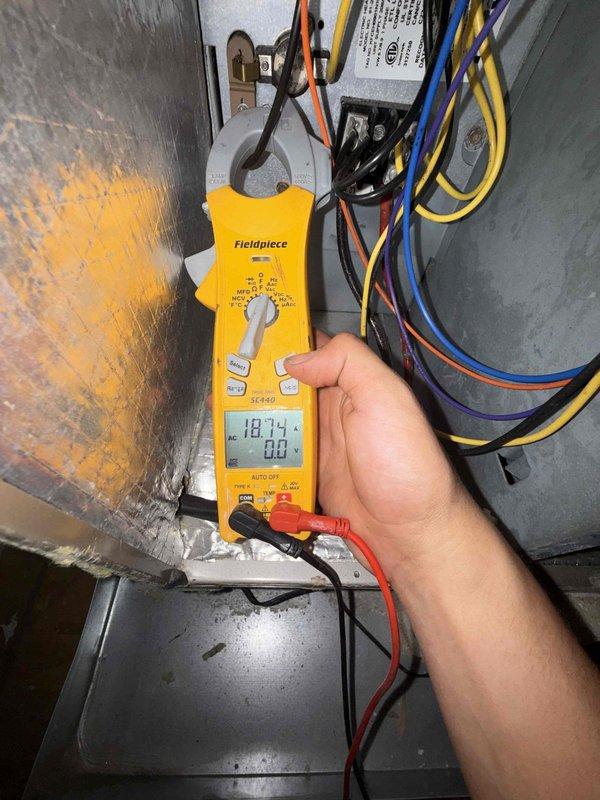 Performed seasonal preventive maintenance on a 3-year-old attic-mounted air handler system. Inspected the unit cabinet, electrical connections, and wiring, and measured amperage draw with a clamp meter (18.74 A). Checked the condensate drain piping, the pan, and the insulated refrigerant lines and ductwork for proper condition and support. Noted discoloration on the cabinet's foil-faced insulation. Previously identified indoor air quality concerns remain open for the customer's consideration.