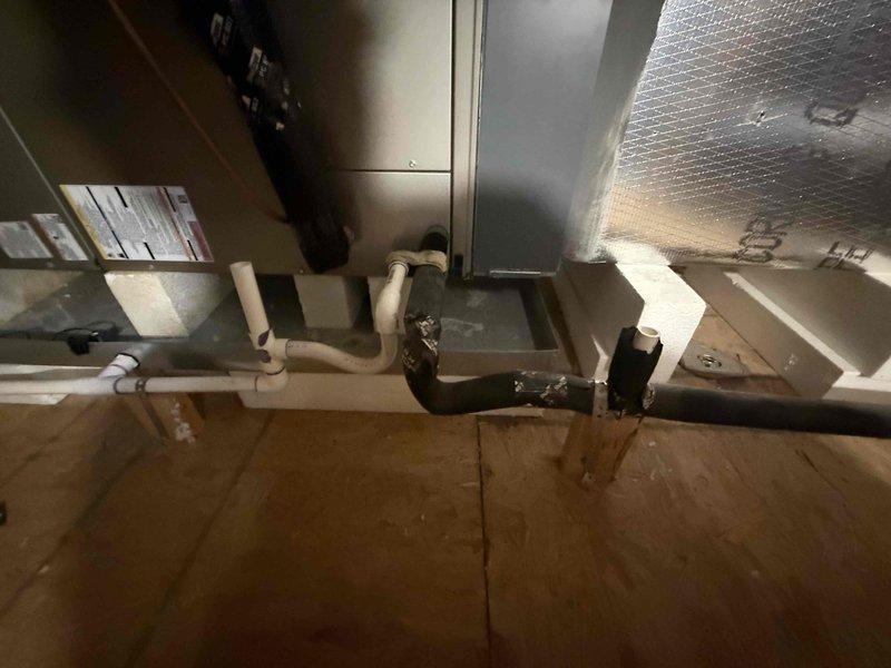 Performed seasonal preventive maintenance on a 3-year-old attic-mounted air handler system. Inspected the unit cabinet, electrical connections, and wiring, and measured amperage draw with a clamp meter (18.74 A). Checked the condensate drain piping, the pan, and the insulated refrigerant lines and ductwork for proper condition and support. Noted discoloration on the cabinet's foil-faced insulation. Previously identified indoor air quality concerns remain open for the customer's consideration.