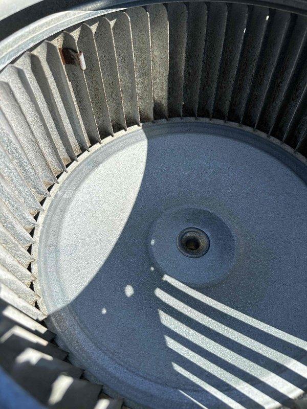 Returned to complete scheduled maintenance on the air handler. Inspected the blower wheel and cabinet interior, noting dust and debris accumulation on the squirrel cage fan blades, rust staining on the foil-faced insulation and cabinet floor, and surface corrosion on the frame and fasteners near the drain pan. Documented all conditions for further evaluation and recommended follow-up as needed.