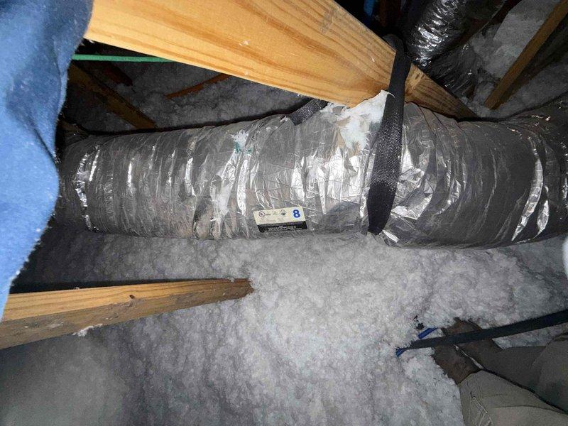 Performed a seasonal preventive maintenance inspection on a single attic-mounted split system. Inspected the 12x24x1 return air filter, which was heavily loaded with dust and debris, and documented its condition for replacement. Inspected the attic flex duct and found torn and frayed foil-faced insulation jacketing with exposed fiberglass, which can lead to thermal loss and condensation; documented for repair. Previously identified restricted return airflow and biological growth in the plenum and evaporator coil remain open items for follow-up.