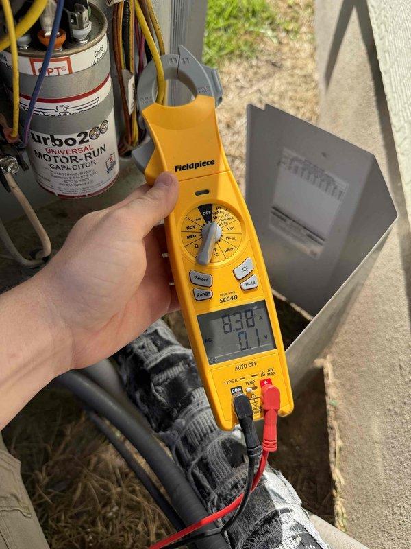 Performed seasonal maintenance inspection on two closet-mounted HVAC systems. Measured condenser motor-run capacitor and amperage draw with a true RMS clamp meter (approx. 8.38 A), confirming electrical operation within normal range. Inspected air handler interior and found heavy buildup, corrosion-like residue, and discoloration on internal components and blower housing, indicating a need for further cleaning and evaluation. Also noted worn, frayed refrigerant line insulation at the outdoor unit that should be replaced to maintain efficiency and prevent condensation issues.