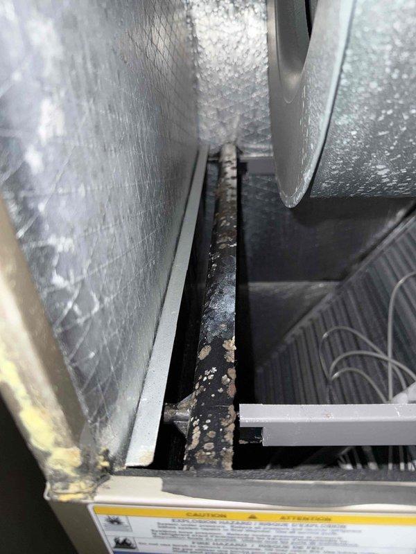 Performed seasonal maintenance inspection on two closet-mounted HVAC systems. Measured condenser motor-run capacitor and amperage draw with a true RMS clamp meter (approx. 8.38 A), confirming electrical operation within normal range. Inspected air handler interior and found heavy buildup, corrosion-like residue, and discoloration on internal components and blower housing, indicating a need for further cleaning and evaluation. Also noted worn, frayed refrigerant line insulation at the outdoor unit that should be replaced to maintain efficiency and prevent condensation issues.