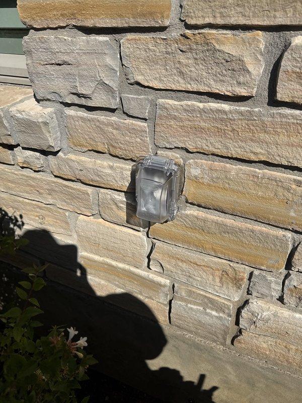 Replaced four exterior weatherproof outlet bubble covers and re-sealed around each outlet with fresh silicone to restore weather protection. Removed the existing above-counter and under-cabinet lighting (six fixtures) and installed ten customer-supplied brown under-cabinet lights per the planned layout, linking fixtures together where possible and neatly securing the wiring along the top of the cabinets near the back wall to keep it concealed.