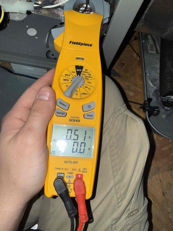 Performed member maintenance inspection on a single attic-mounted split system. Measured blower motor amperage at 0.51 A with a true RMS clamp meter. Found frost/ice buildup on the insulated refrigerant lines and fittings at the base of the air handler, which indicates a restricted airflow or low refrigerant charge condition. Condensate drain piping and secondary drain pan were inspected. Further diagnosis of airflow and refrigerant charge is recommended to determine the cause of the freeze-up.