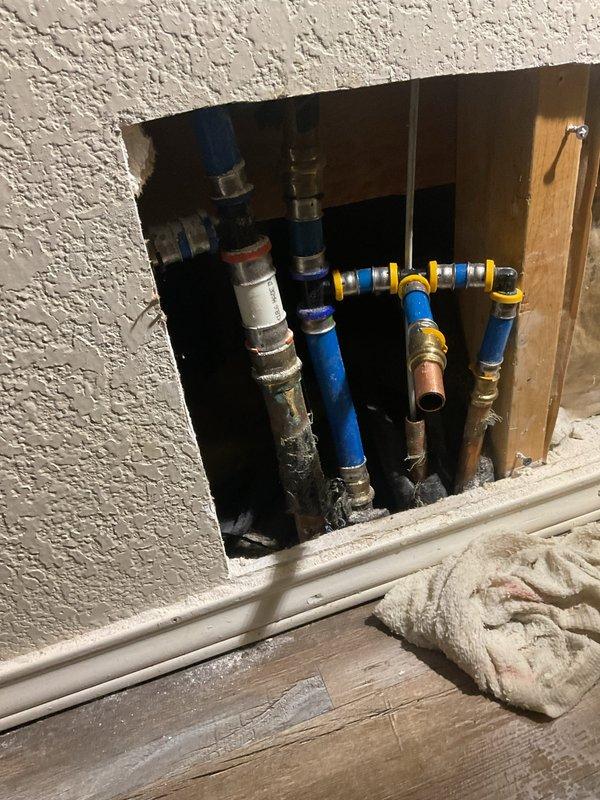 Performed a Level 5 slab leak isolation diagnostic on a suspected hot-side leak, using manifold isolation testing and line tracing to identify the affected hot water line. Accessed the manifold and associated PEX and copper supply lines by cutting an inspection opening in the drywall, and documented the exposed piping with photos. The affected line is now narrowed down for repair recommendations, with no excavation, slab penetration, or repair performed during this diagnostic.