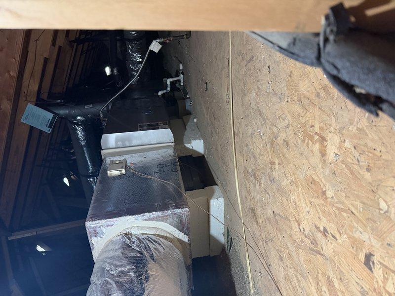 Performed maintenance inspection on a 19-year-old attic-installed furnace and air handler, identifying a leaking blower motor, a motor capacitor out of tolerance, and a dirty flame sensor that remained unserviceable after cleaning. Documented system condition with photos and recommended replacement of the failing components, with the aging equipment flagged as a candidate for system replacement evaluation.
