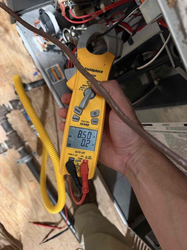 Responded to a thermostat fault indicating "R-wire not connected" on the downstairs system and inspected the thermostat wiring and control circuit. Verified the Nest thermostat was calling for Stage 2 cooling and used a clamp meter to confirm the system was drawing current at 8.5 amps, indicating the equipment was energized and operating. Control wiring restored and system confirmed operational in cooling mode.