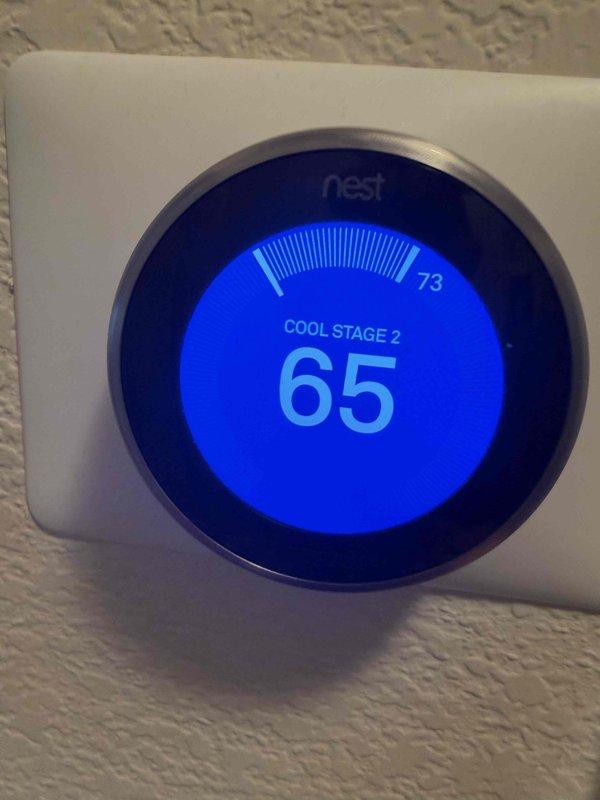 Responded to a thermostat fault indicating "R-wire not connected" on the downstairs system and inspected the thermostat wiring and control circuit. Verified the Nest thermostat was calling for Stage 2 cooling and used a clamp meter to confirm the system was drawing current at 8.5 amps, indicating the equipment was energized and operating. Control wiring restored and system confirmed operational in cooling mode.
