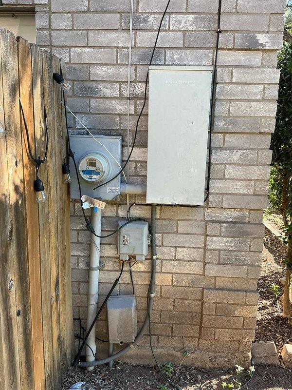 Performed an on-site evaluation of the existing exterior main electrical service for a replacement quote. Inspection found a 30-year-old meter and main panel with severe discoloration and oxidation, no main breaker disconnect, no whole-home surge protection, outdated breakers, inadequate grounding, and a dryer circuit deficiency. Documented the findings and recommended a full main service replacement to bring the system up to current code and safety standards.