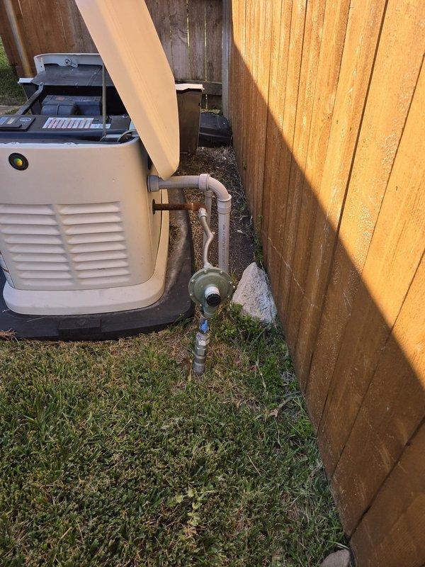 Performed annual maintenance on the standby generator, inspecting the enclosure, control panel, and indicator lights, which showed normal operation. Inspected the gas supply line and regulator and noted surface rust on the short steel pipe section at the generator connection. Opened and inspected the automatic transfer switch enclosure, including the 200A breaker, wiring, and terminations, and noted bundled wiring with several loose conductor ends.