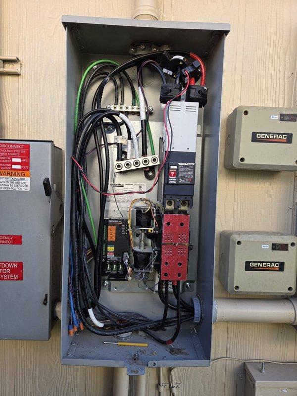 Performed annual maintenance on the standby generator, inspecting the enclosure, control panel, and indicator lights, which showed normal operation. Inspected the gas supply line and regulator and noted surface rust on the short steel pipe section at the generator connection. Opened and inspected the automatic transfer switch enclosure, including the 200A breaker, wiring, and terminations, and noted bundled wiring with several loose conductor ends.