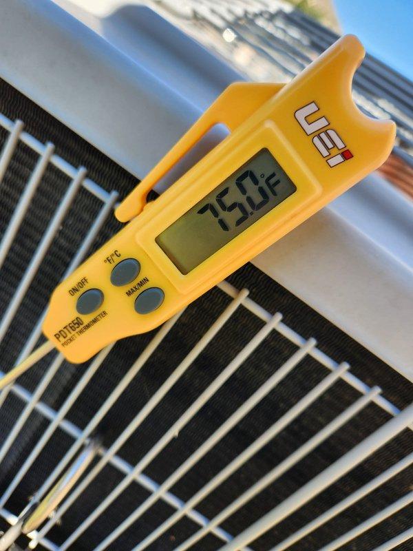 Performed seasonal maintenance on a single-system residential split HVAC unit with the air handler located in the attic. Verified the outdoor condenser was clean and free of frost, ice, or visible corrosion, and recorded an ambient outdoor air temperature of 75°F with a calibrated pocket thermometer. Used a digital level to confirm the equipment was sitting level at 0.1°, and confirmed the system was operating normally with no issues noted.