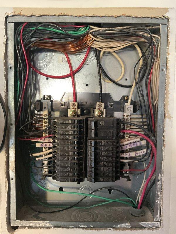 Troubleshot tripping exterior outlets by tracing the GFCI source outlet in the garage and inspected the original 2001 service panel, which showed dense, crowded branch circuit wiring and labeled GFI circuits at the bus bars. Replaced ceiling fans at 8–10 ft heights throughout the home, and installed a dimmer switch as part of the completed work.