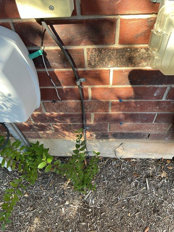 Performed a whole-home electrical maintenance inspection, including evaluation of both service panels (one exterior, one interior) and the exterior meter and conduit connections. Verified the exterior service entrance cable, conduit, and mounting hardware were secure, with no visible damage or deterioration, and inspected the interior smoke detector for proper mounting and condition, with no signs of damage or discoloration. Panel age remains undetermined and was noted for future reference given the age of the home.