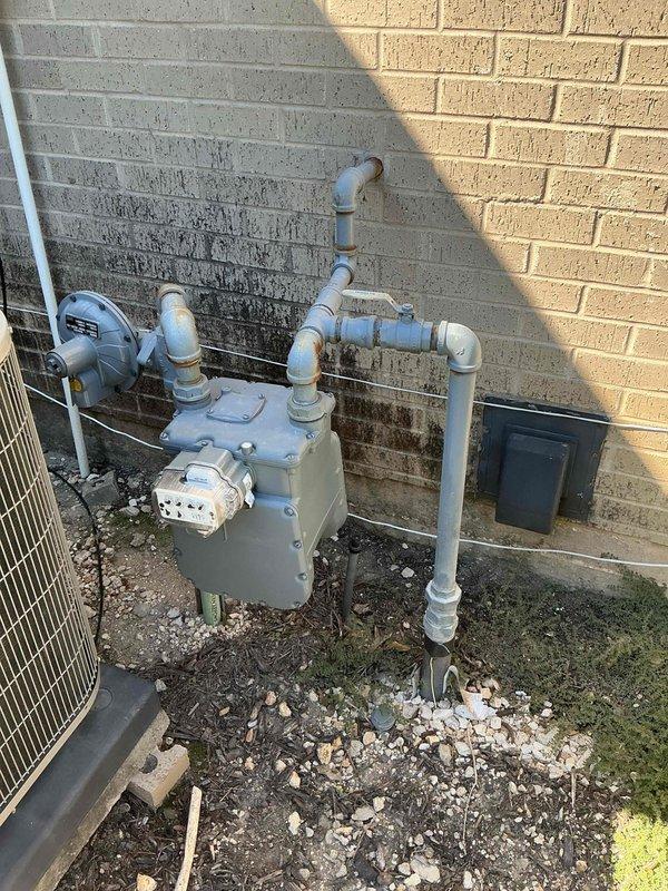 Removed the existing Rheem gas tank-type water heater, including the expansion tank and flexible gas connector, and installed a gas tankless water heater with new venting, gas supply connections, and isolation valves. Inspected the exterior gas meter and regulator assembly serving the unit and verified a two-year-old PRV and shutoff combination was functioning properly. Tested the system for gas leaks, proper combustion, and hot water delivery, and enrolled the property in a maintenance membership plan.