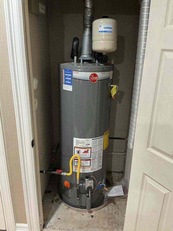 Removed the existing Rheem gas tank-type water heater, including the expansion tank and flexible gas connector, and installed a gas tankless water heater with new venting, gas supply connections, and isolation valves. Inspected the exterior gas meter and regulator assembly serving the unit and verified a two-year-old PRV and shutoff combination was functioning properly. Tested the system for gas leaks, proper combustion, and hot water delivery, and enrolled the property in a maintenance membership plan.