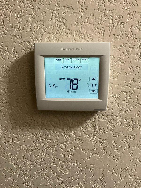 Responded to a recurring thermostat complaint where the indoor temperature was overshooting the setpoint. Inspected the Honeywell Home wall thermostat and observed the system in heat mode with the space reading 78° against a 71° setpoint, confirming heat was running past the call. Accessed the thermostat's menu and diagnostic display to verify settings and screen function (segment check displayed normally, fan set to auto circulation). Documented thermostat operation and overshoot condition for further evaluation of the control and its wiring/calibration.