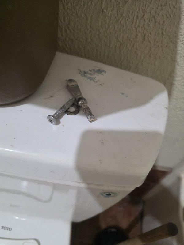 Performed a plumbing maintenance visit on a 1978 residence with a gas, tank-style water heater, and evaluated the secondary bathroom tub, which has been non-functional for several years, to establish a baseline for repair or replacement. Inspected the toilet tank and found corroded, degraded tank hardware, including a deteriorated bolt and washer with mineral staining on the lid, and noted dust and debris buildup with rust staining at the wall and surface junction. Findings were documented for repair and replacement planning.