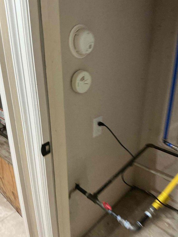 Installed a new GFCI-protected receptacle in the utility closet to serve the tankless water heater, mounting it with a matching cover plate and securing it to the wall. Connected the unit's power cord to the receptacle and verified proper operation, with the cord routed cleanly away from the gas piping and fittings.
