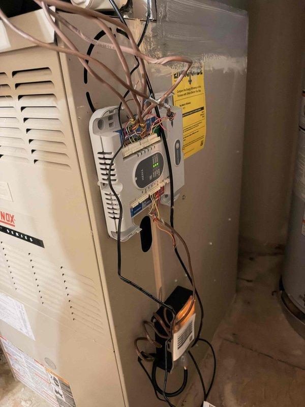 Performed a member maintenance inspection on the residential split system, evaluating the Lennox furnace control module and the outdoor condenser's electrical compartment. Found loose, unsecured low-voltage and line-voltage wiring at the furnace control module and transformer, and observed worn, frayed wire insulation near the grommet at the condenser's electrical compartment, with the contactor and capacitor otherwise intact and no frost, rust, or visible damage. Documented conditions for follow-up, with wire management and insulation repair recommended; condenser age was previously noted as original, and replacement options remain open.