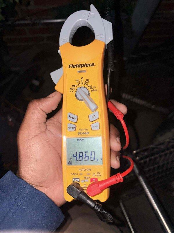 Diagnosed a no-airflow complaint on the HVAC system. Performed electrical testing with a True RMS clamp meter, capturing a capacitor reading of 4.86 µF and a compressor/condenser fan motor inrush current of 91.4 A during startup to assess capacitor and motor performance. Findings should be reviewed against the nameplate ratings to determine any required component repair or replacement.