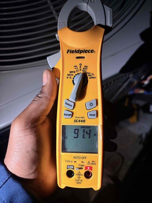 Diagnosed a no-airflow complaint on the HVAC system. Performed electrical testing with a True RMS clamp meter, capturing a capacitor reading of 4.86 µF and a compressor/condenser fan motor inrush current of 91.4 A during startup to assess capacitor and motor performance. Findings should be reviewed against the nameplate ratings to determine any required component repair or replacement.