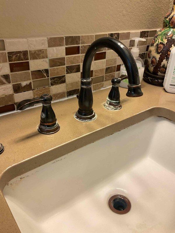 Repaired the toilet in the secondary unit above the garage, which required manual tank refilling, by servicing the tank fill and flush components and restoring proper automatic water level and refill operation. Replaced the elongated toilet seat and secured the assembly, then installed a new widespread bathroom faucet with two handles and a center spout at the vanity, replacing the existing oil-rubbed bronze unit that had heavy mineral buildup. Verified all connections for leaks and confirmed proper operation of the toilet and faucet.