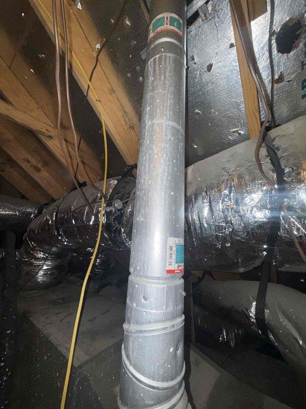 Performed seasonal preventative maintenance on a single attic-mounted HVAC system, accessing the unit and inspecting the air handler, ductwork, and flue/vent piping. Used handheld diagnostic instruments to take system measurements and evaluate performance, and observed the reflective-wrapped flexible duct runs and metal vent pipe for condition and integrity. Previously identified issues, including conditioned air leakage into the attic, remain on record for follow-up.