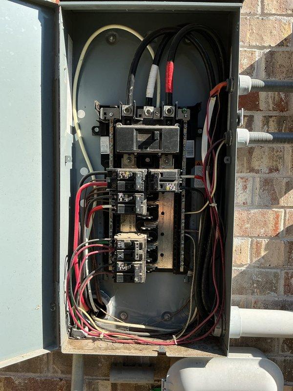 Responded to a service call for two separate branch circuits repeatedly tripping, serving the washer and coffee machine. Performed a visual inspection of the exterior-mounted main electrical panel, documenting breaker arrangement, conductor routing, and enclosure condition, and noted loosely routed conductors within the panel and heavy corrosion on the adjacent exterior conduit and fittings near the service entrance. Findings were documented with photos to support further diagnostics and recommended corrective repairs.