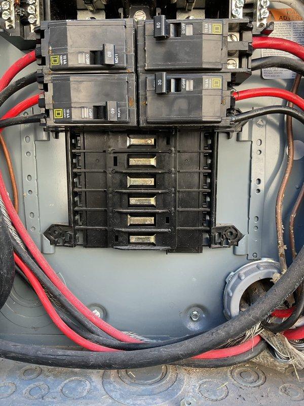 Performed an electrical member maintenance inspection of the main breaker panel, visually assessing the Square D breakers, bus stabs, conductor routing, and neutral/ground bus terminations. Observed multiple unused bus stab positions with exposed contacts, along with dust and grime buildup inside the enclosure. Documented panel interior condition with photographs for the service record.
