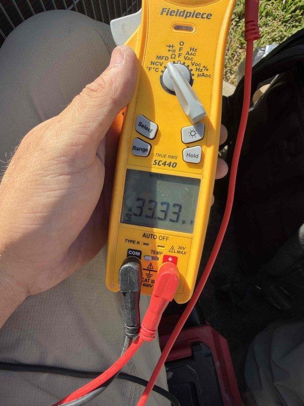 Performed A/C cooling maintenance on two 2020 split systems, with attic air handlers and outdoor condensing units serviced ahead of a home inspection. Electrical testing at the outdoor unit included capacitor microfarad measurement (33.33 µF reading) and condenser amp draw verification (6.10 A on the monitored circuit), and the contactor, wiring, and connections were inspected with no visible damage, rust, or debris concerns noted.