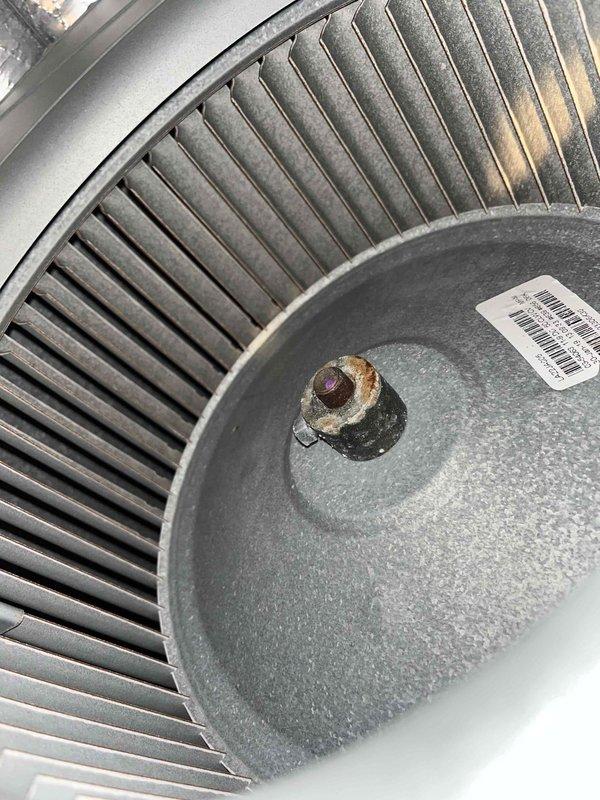 Performed diagnostic evaluation of a single attic-mounted split system for condenser short cycling reported during routine maintenance. Inspected the outdoor unit control compartment and tested the dual-run capacitor with a clamp meter, verifying wiring connections and finding no visible damage, frost, or breakage. Inspected the indoor blower assembly and found heavy rust and corrosion on the blower wheel hub and shaft, which may contribute to airflow and operating issues; further repair recommendations were documented.