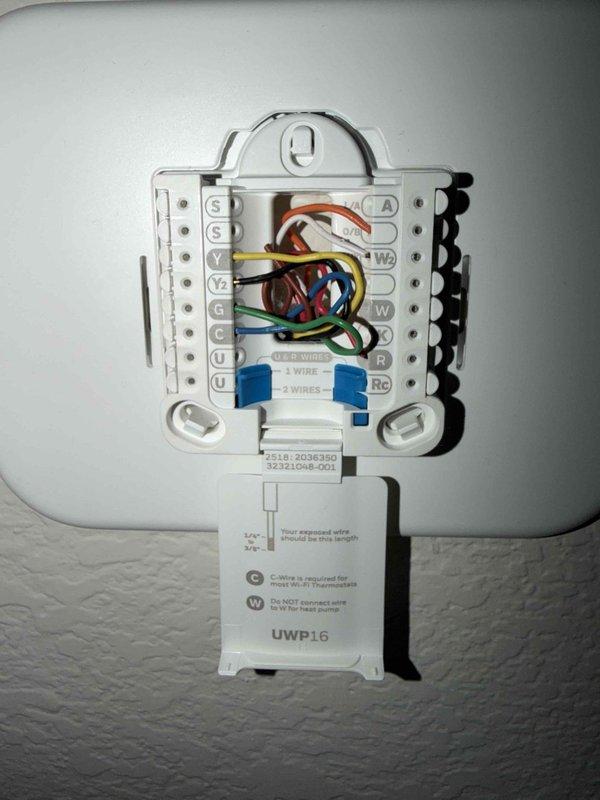 Performed first scheduled maintenance on a 6-month-old 2-zone heat pump system located in the attic, which was clean, safe, and accessible. Inspected the HZ322 zone control panel and verified proper operation, with Home and Config status LEDs active and fan and zone indicators responding correctly. Checked the thermostat wall plate and confirmed secure wire terminations at the R, Rc, C, Y, Y2, W, and W2 terminals. System is performing well with no hot or cold spots reported.