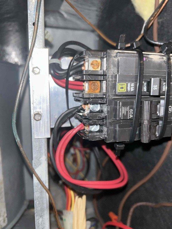 Returned to site and installed a new Square D 35A circuit breaker in the equipment cabinet, securing it with zip ties and terminating the line and load conductors at the breaker lugs. Inspected the existing wiring, noting dust accumulation and discolored, corroded terminal lugs with frayed conductor strands, and verified all connections were tight and properly seated. Restored power and confirmed the breaker was operating correctly.