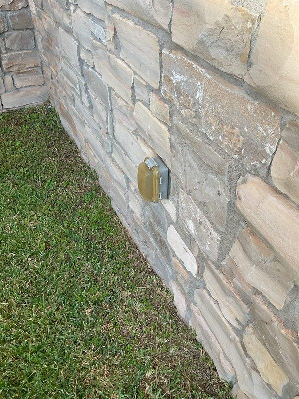Performed a member electrical maintenance inspection on a 2007-built residence with two breaker boxes (laundry area and exterior near the AC condenser). Visually inspected the exterior utility meter enclosure and service entrance components, finding the digital meter, enclosure, and conduit connections in serviceable condition with no signs of rust, frost, or damage. Also inspected the exterior weatherproof GFCI-type receptacle with in-use cover, which was properly mounted flush and intact.