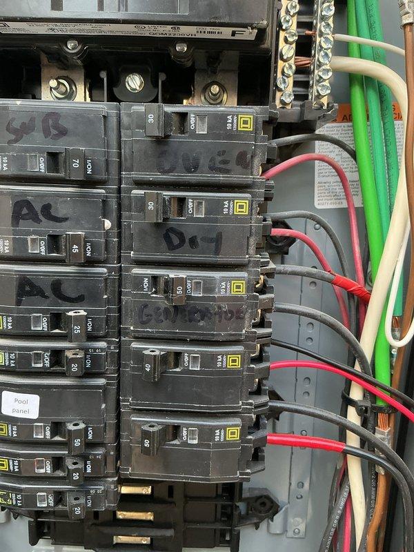 Inspected the main electrical panel and the dryer circuit as part of a GFCI breaker evaluation for the dryer. Examined the main lugs, conductor terminations, neutral/ground bus, and branch breakers for signs of overheating, loose connections, or damage. Verified the dryer, oven, generator, and sub-panel breakers were properly rated and labeled. Observed no burn marks, rust, or visible damage, though a grainy residue was noted on the main lug surfaces and some breaker handle bases. Panel was left in working condition.