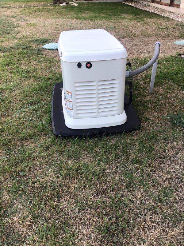 Responded to a standby generator showing a red fault indicator and loss of communication. Opened the enclosure and performed a visual inspection of the control panel, auxiliary shutdown switch, cooling hose routing, and engine compartment, noting light dust and cobweb buildup with no visible rust, frost, or physical damage. Verified the unit is seated on its composite pad with the flexible conduit connection intact.