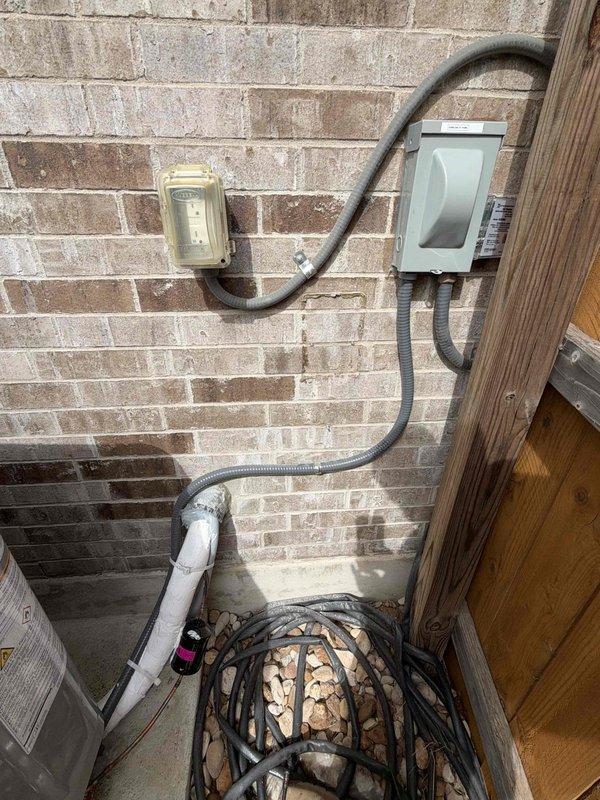 Returned to site to complete the HVAC system installation. Verified thermostat operation in FAN AUTO mode and confirmed the displayed setpoint against a calibrated probe thermometer reading. Inspected the outdoor condensing unit connections, including the electrical disconnect, flexible conduit, and insulated refrigerant line set, and found all components properly secured with no visible damage.