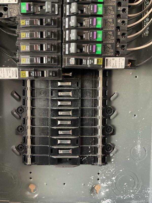 Performed a member electrical maintenance inspection of both breaker enclosures, the garage sub panel and the exterior-mounted service panel, in a two-year-old home. Visually inspected the Square D breakers, bus bar assemblies, conductors, and enclosure interiors, noting AFCI/GFCI combination breakers in the garage panel and 30A/50A breakers with intact cable routing in the exterior panel. Observed no signs of overheating, damaged conductors, or loose terminations, and noted minor construction dust and debris in the enclosures, with open breaker spaces available for future circuit additions.