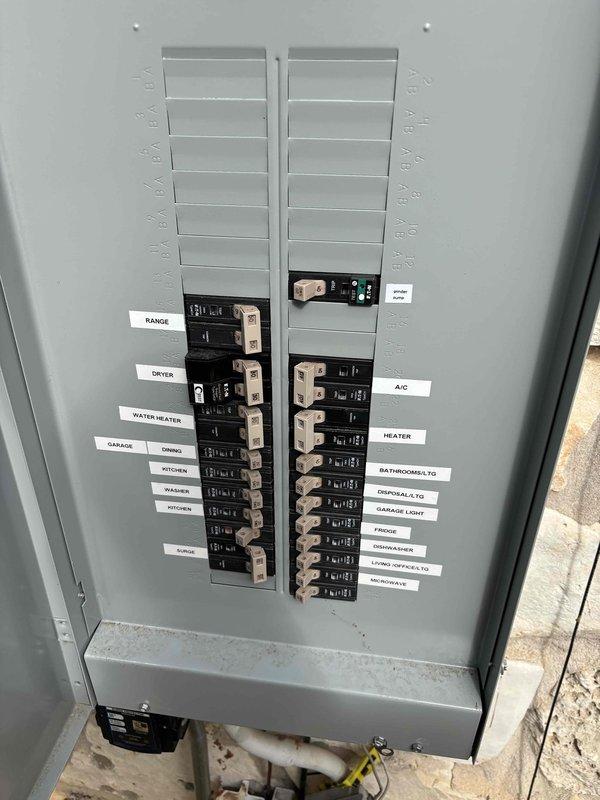 Evaluated the electrical panel and available circuit capacity for the installation of a dedicated circuit to serve a new ejector pump. Inspected the main service panel, confirmed circuit labeling, and verified the existing circuit schedule, including the sump circuit. Tested the exterior weatherproof receptacle with a Fluke T5-600 and confirmed proper voltage of approximately 123 volts. Scope of work was reviewed on site to support the dedicated ejector pump circuit installation.