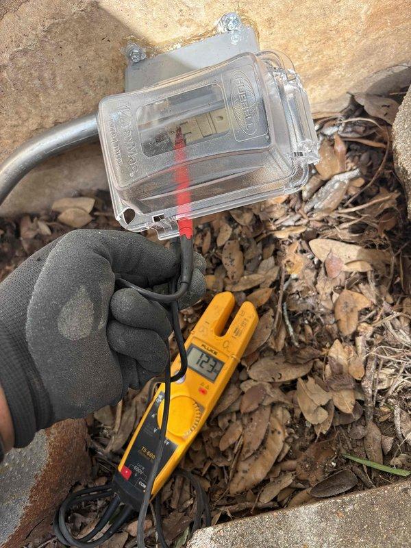 Evaluated the electrical panel and available circuit capacity for the installation of a dedicated circuit to serve a new ejector pump. Inspected the main service panel, confirmed circuit labeling, and verified the existing circuit schedule, including the sump circuit. Tested the exterior weatherproof receptacle with a Fluke T5-600 and confirmed proper voltage of approximately 123 volts. Scope of work was reviewed on site to support the dedicated ejector pump circuit installation.