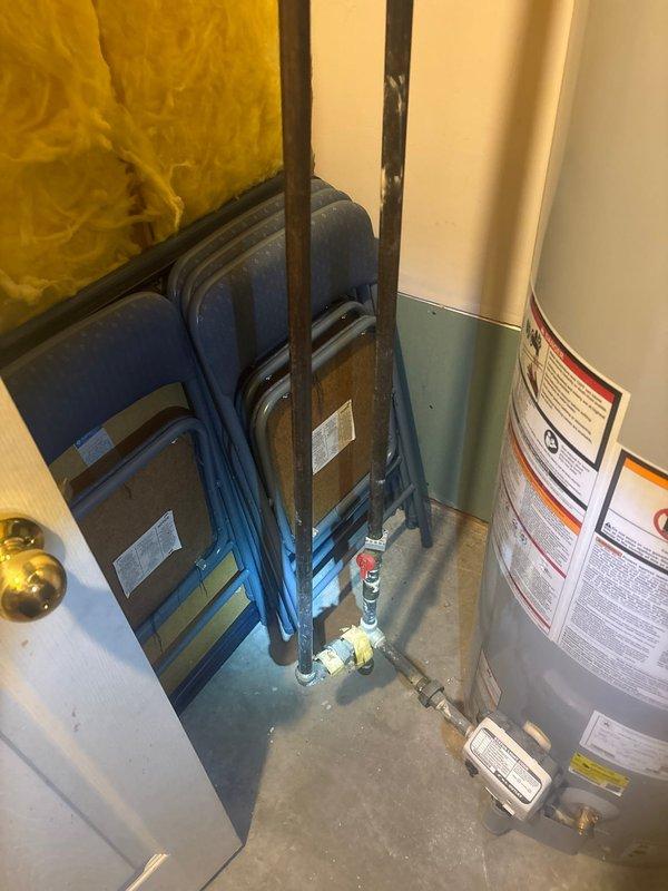 Performed water leak detection service in response to customer's report of substantially increased water bills as flagged by local water department. Conducted thorough inspection of utility room containing water heater installation, paying particular attention to visible copper plumbing lines and connections. Examined areas with exposed fiberglass insulation for signs of moisture or water damage to identify potential leak source.